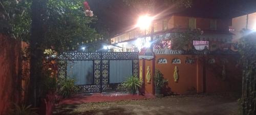 a house with a gate at night with a street light at Reegina Villa in Chunnakam