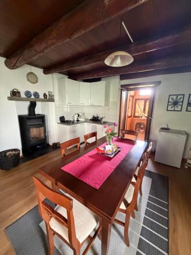 a kitchen and dining room with a table and chairs at Rustico Corte in Brissago