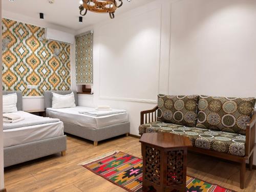 a living room with a couch and a table at Ulli Oy Boutique & Terrace in Khiva