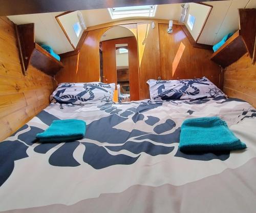 a bed in the back of a boat with blue pillows at Miramare in Playa Blanca