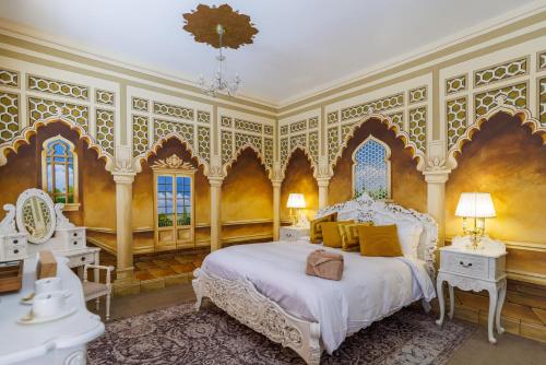 a bedroom with a white bed and yellow walls at Thomas Paine Hotel in Thetford