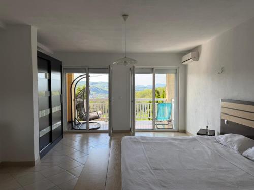 a bedroom with a bed and a view of a balcony at Villa Rest Ilijas 4 bedrooms in Ilijaš