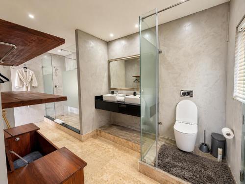 a bathroom with a toilet and a sink at Vetho House in Ballito