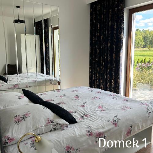 a bedroom with two beds and a mirror at Apartamenty Ku Dolinie in Wilków