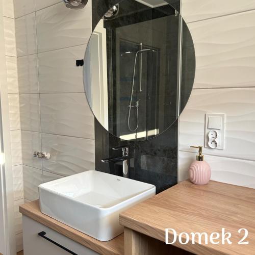 a bathroom with a sink and a mirror at Apartamenty Ku Dolinie in Wilków