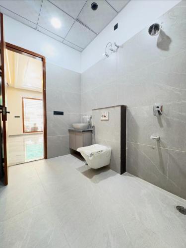 a bathroom with a toilet and a shower at Hotel king palace family stay in Agra