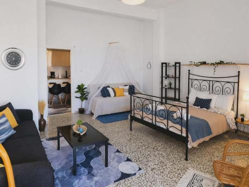 a living room with a bed and a couch at ON THE SAND apartment in Artemida