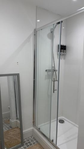a glass shower in a bathroom with at Beach & city Homestay in Waterloo