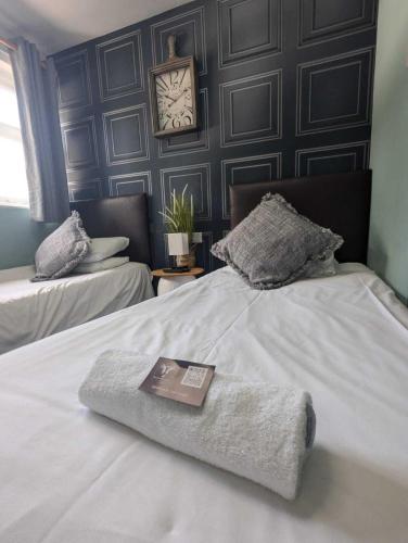 a hotel room with a bed with a book on it at The Crafty Cow in Bristol