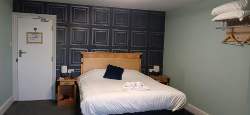a bedroom with a bed with a blue pillow on it at The Crafty Cow in Bristol