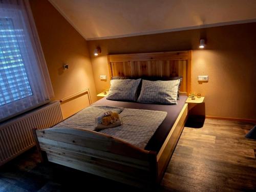 a bedroom with a bed with a dog on it at Apartma Jurka in Podčetrtek