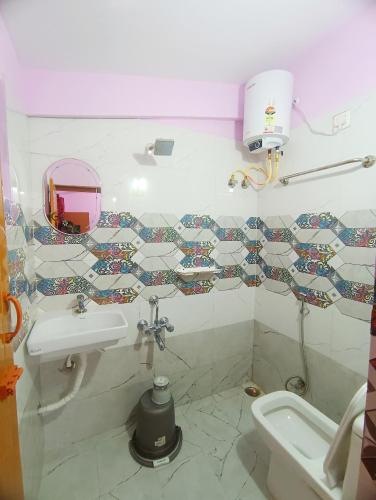 a bathroom with a sink and a toilet at Ooty Gate Residency in Ooty