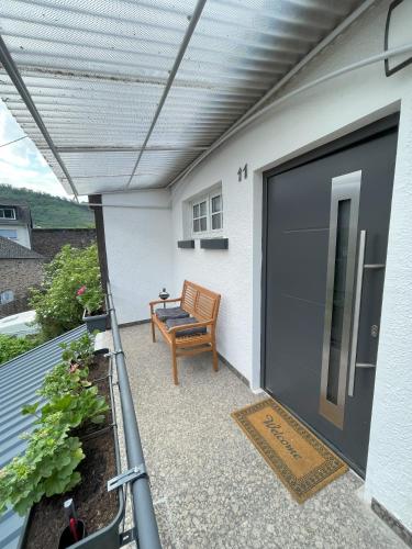 a garage door with a bench on a patio at Ferienhaus Mediterran in Bruttig-Fankel für 2-5 Personen in Bruttig-Fankel
