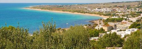 a view of a beach with houses and the ocean at B&B Monteleo Salento in Morciano di Leuca
