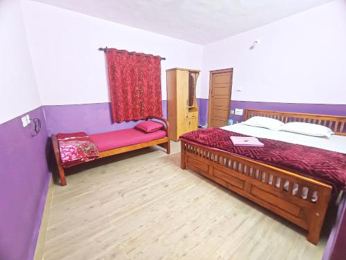 a bedroom with a bed and a chair in it at Ooty Gate Residency in Ooty