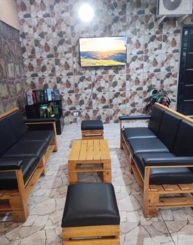 a living room with couches and tables and a tv at Habitaciones de alquiler in La Libertad
