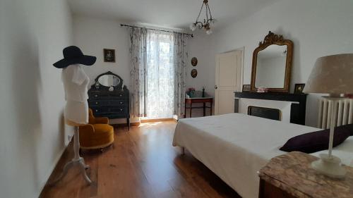 a bedroom with a bed and a dresser and a mirror at Appart charme Arenes Nimes in Nîmes