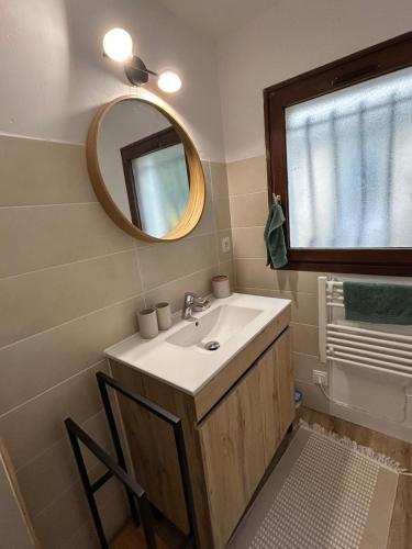 a bathroom with a sink and a mirror at Panach in Saint-Loubès