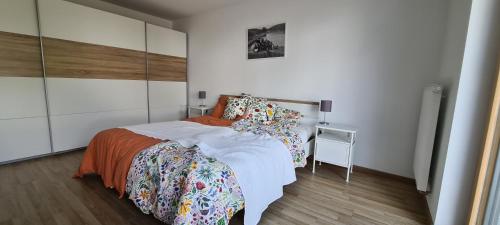 a bedroom with a large bed and a night stand at Spessartblick Eisingen in Eisingen