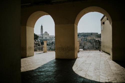 an archway in a building with a view of a city at Il Palazzotto I Residence & Winery in Matera