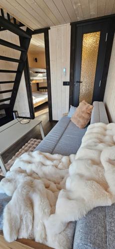 a bed with a pile of fur on top of it at WAKE INN by Pidu-LA in Abula