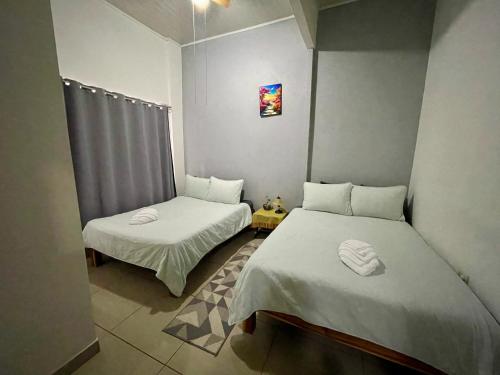 a room with two beds in a room at Heliconia Suite 5min to Waterfall - Shared Pool Pool in Fortuna