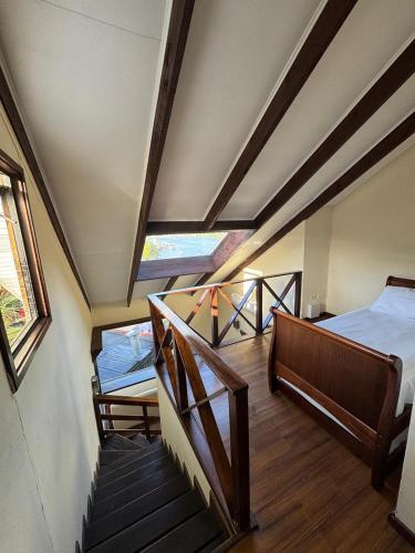 a attic room with two beds and a staircase at Cabañas del Puerto in Puerto Montt