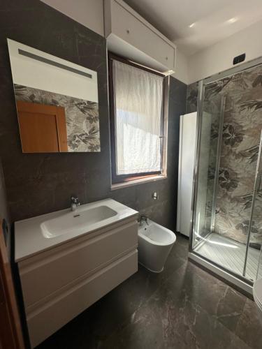 a bathroom with a tub and a sink and a shower at Domus Leonardo Apartment in Fiumicino Airport