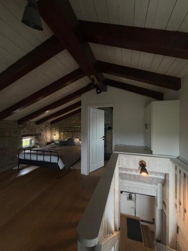 a bedroom with a bed and a kitchen with a counter at Vila EVANA in Sečovlje