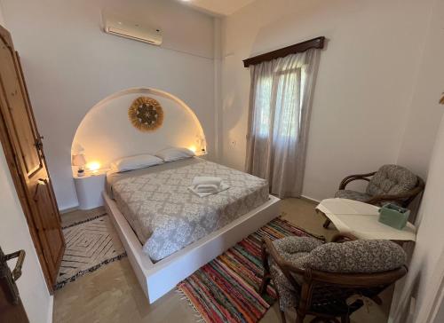 a bedroom with a bed and a table and chairs at Villa Evdokia in Kalymnos