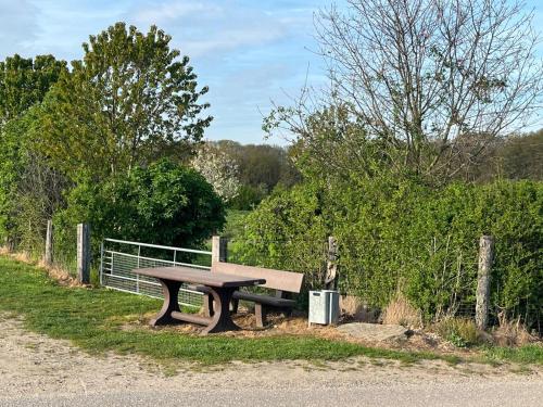 a wooden bench sitting on the side of a road at Ferienwohnung Varbrook in Niederkrüchten