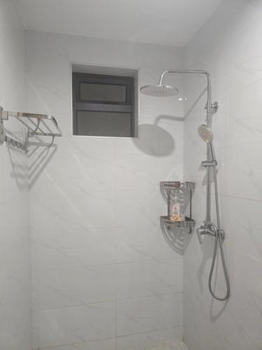 a bathroom with a shower with a glass door at Serene Studio near UN headquarters and Gigiri in Ruaka