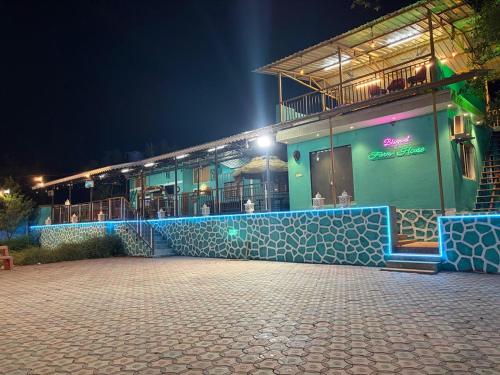 a building with blue lights on it at night at Bhogwal farm house in Karjat