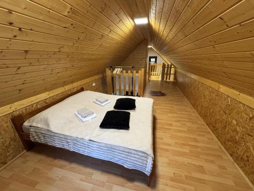a bedroom with a bed in a wooden room at Secret Forest Retreat in Ptujska Gora