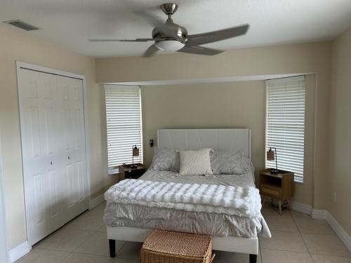 a bedroom with a bed and a ceiling fan at Salted Sunset at Punta Gorda Isles in Punta Gorda