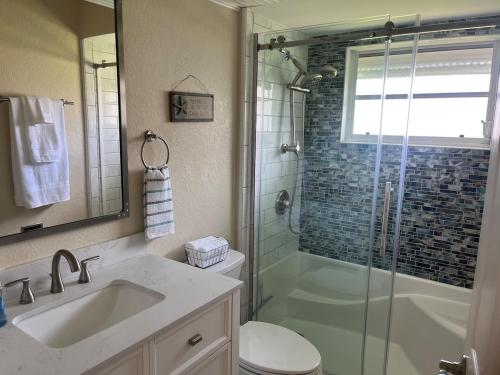 a bathroom with a shower and a toilet and a sink at Salted Sunset at Punta Gorda Isles in Punta Gorda