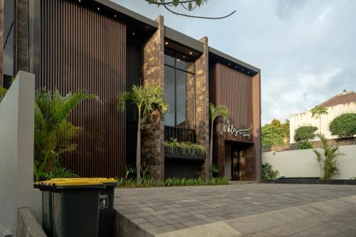 a building with a courtyard with plants on it at Miles Coliving Bali, close to Seminyak and Canggu in Kerobokan