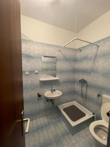 a bathroom with a sink and a toilet at Apartments Adriatic Nest in Omiš