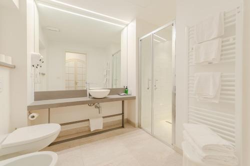 a bathroom with a toilet and a sink and a shower at Promenade Maison de Charme in Sanremo