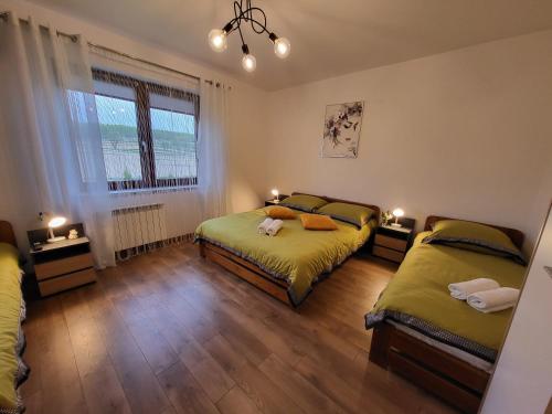 a bedroom with two beds and a window at Józefinka House of Energylandia Zator in Spytkowice