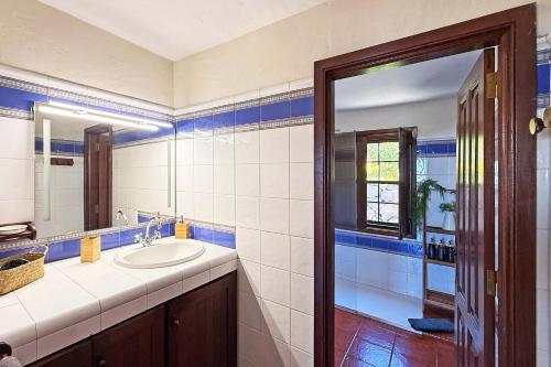 a bathroom with a sink and a mirror at Casa El Colmenero in Garafía