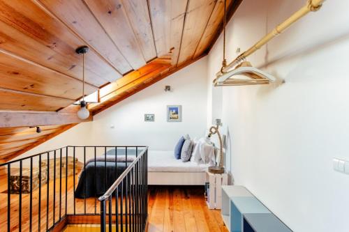 a room with a bed and a wooden ceiling at Baixa Heritage Apartments by Cathedral & Tram 28 by NestAtLisbon in Lisbon