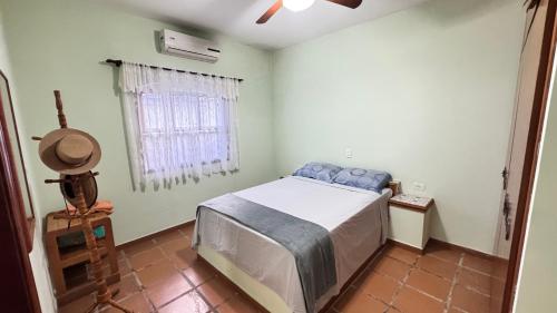 a bedroom with a bed and a window at Casa Lar Doce Mar Juquehy in São Sebastião