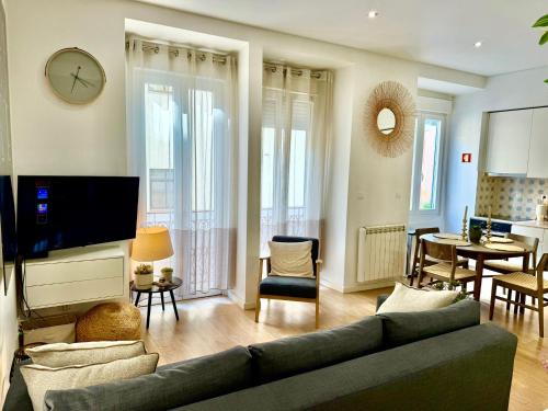 a living room with a couch and a dining room at Intendente Terrace in Lisbon
