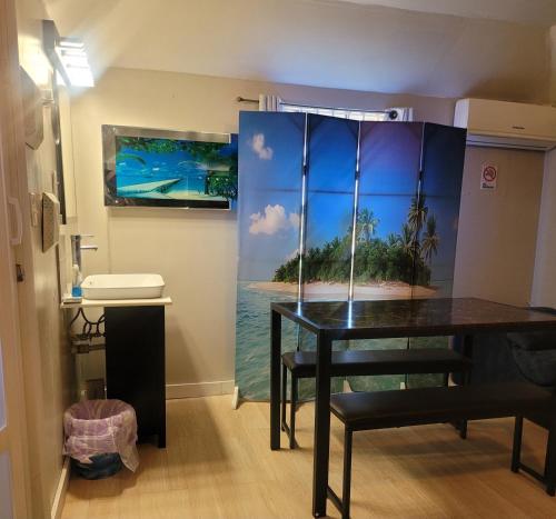 a dining room with a table and a picture of a beach at Cocoplum Rest N Hideaway #2 in Nassau