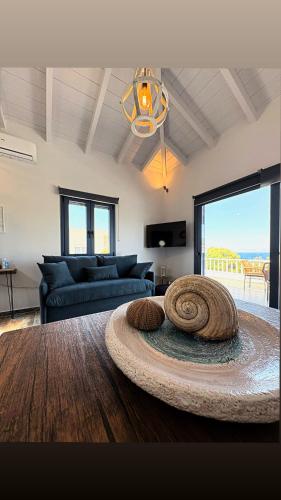 a living room with a couch and a table at The Dona House in Vaia