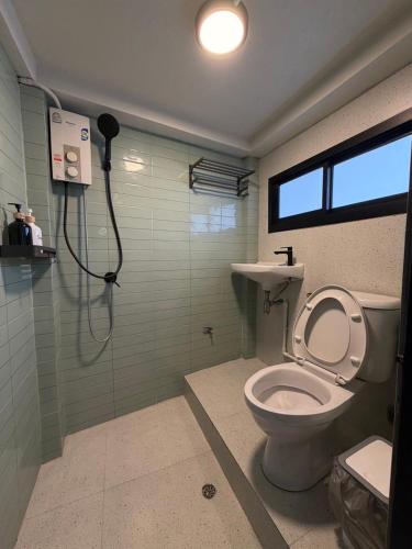 a bathroom with a shower and a toilet in it at Casa Yu in Hat Yai
