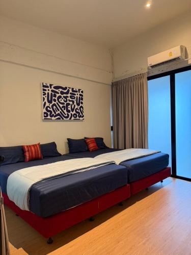 a bedroom with a large bed in a room at Casa Yu in Hat Yai