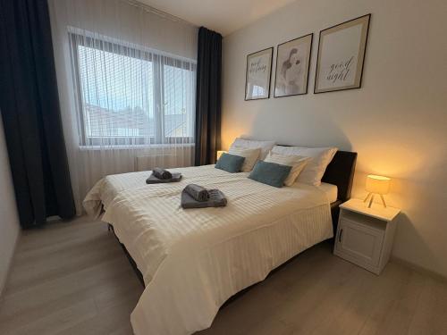 a bedroom with a bed with two towels on it at Apartman SPORKA in Púchov