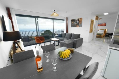 a living room with a table with a bowl of fruit on it at CASA PANORAMA SOL- NEW VILLA WITH HEATED SALTWATER POOL and FANTASTIC SEA VIEW in Ponta do Sol